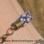 دستبند نخی طرح گره رنگ بنفش و سرمه‌ای و صورتی