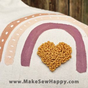 کیف توت بگ طرح رنگین کمان صورتی کمرنگ و قلب کرم