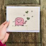 کارت پستال پارچه‌ای طرح فیل صورتی با قلب‌های سبز